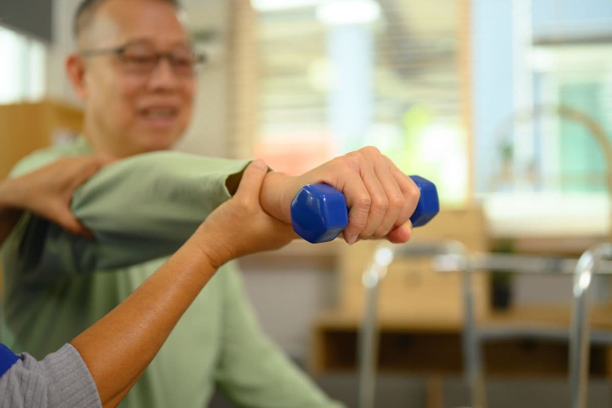 Physiotherapist helping a patient with rehabilitation exercises