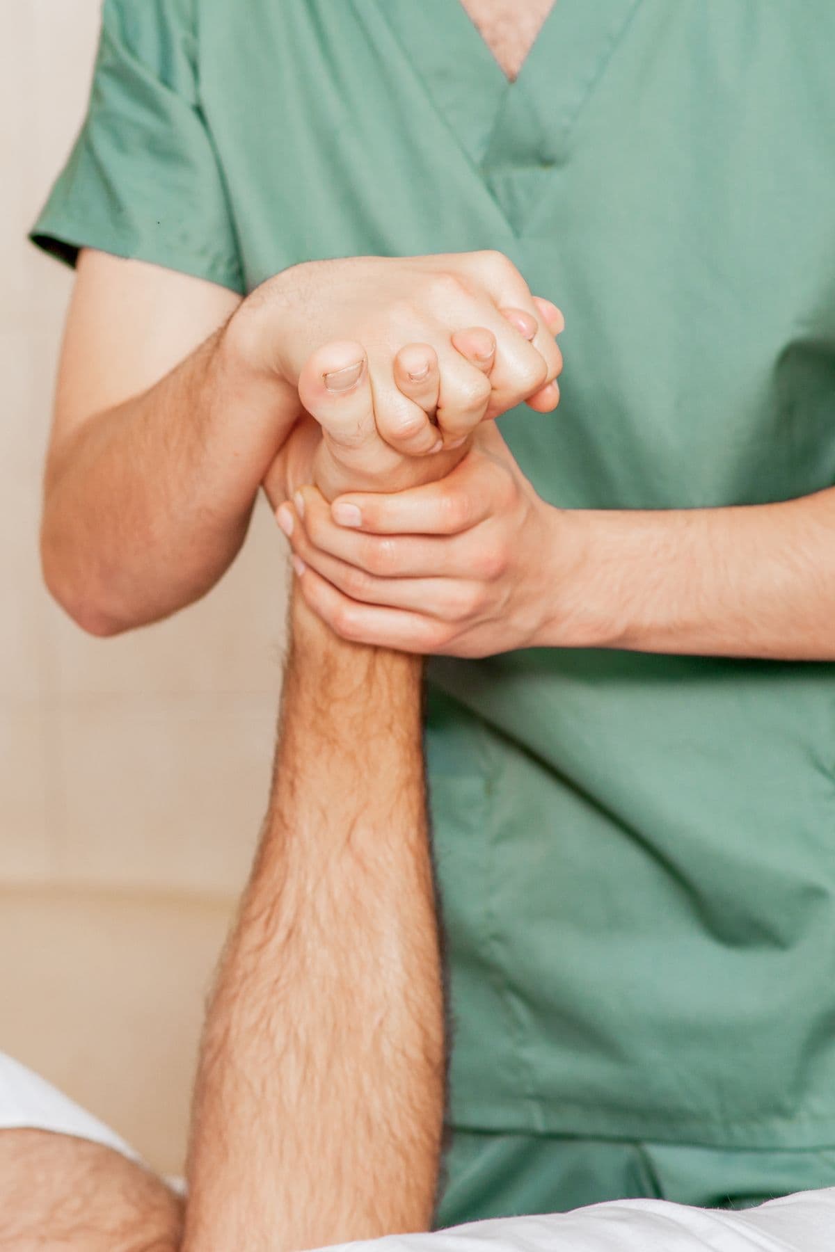 Close-up of massage therapist hands performing therapy